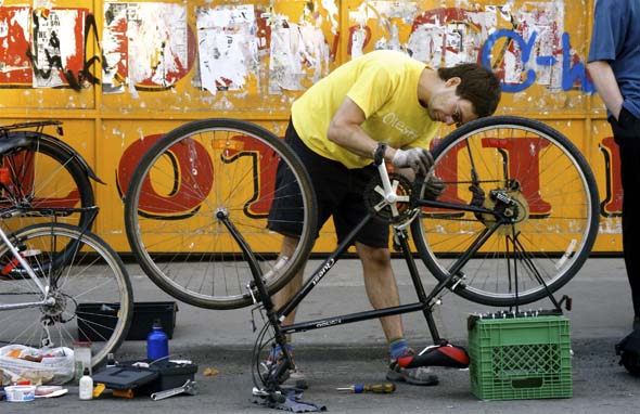 Toronto Bike's Dan T. fixes a bike in Kensington Market