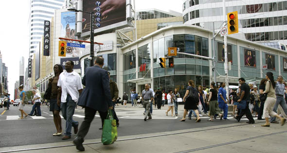 Pedestrians Scramble at Yonge & Dundas Intersection in Toronto
