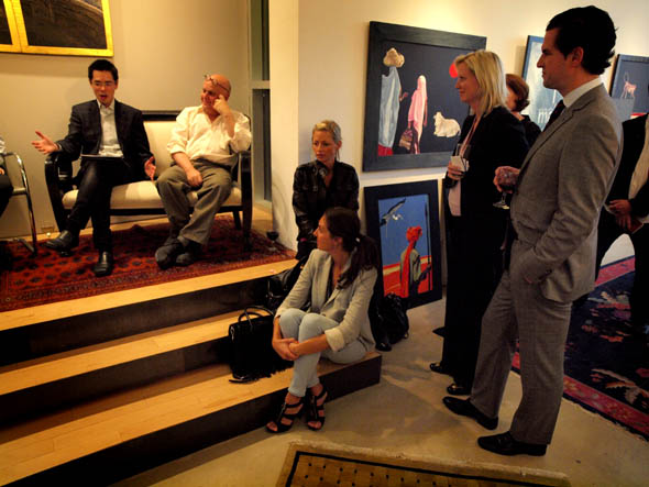 Charles Pachter and Derek Wong talk to guests at Art Of Living event